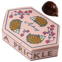 Audrey’s Chocolates A Prickle Of Hedgehogs Chocolate showing box and 1 piece of hedgehog chocolate