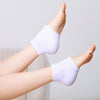 A pair VOESH Moisturizing Heel Socks in purple worn on a person's feet