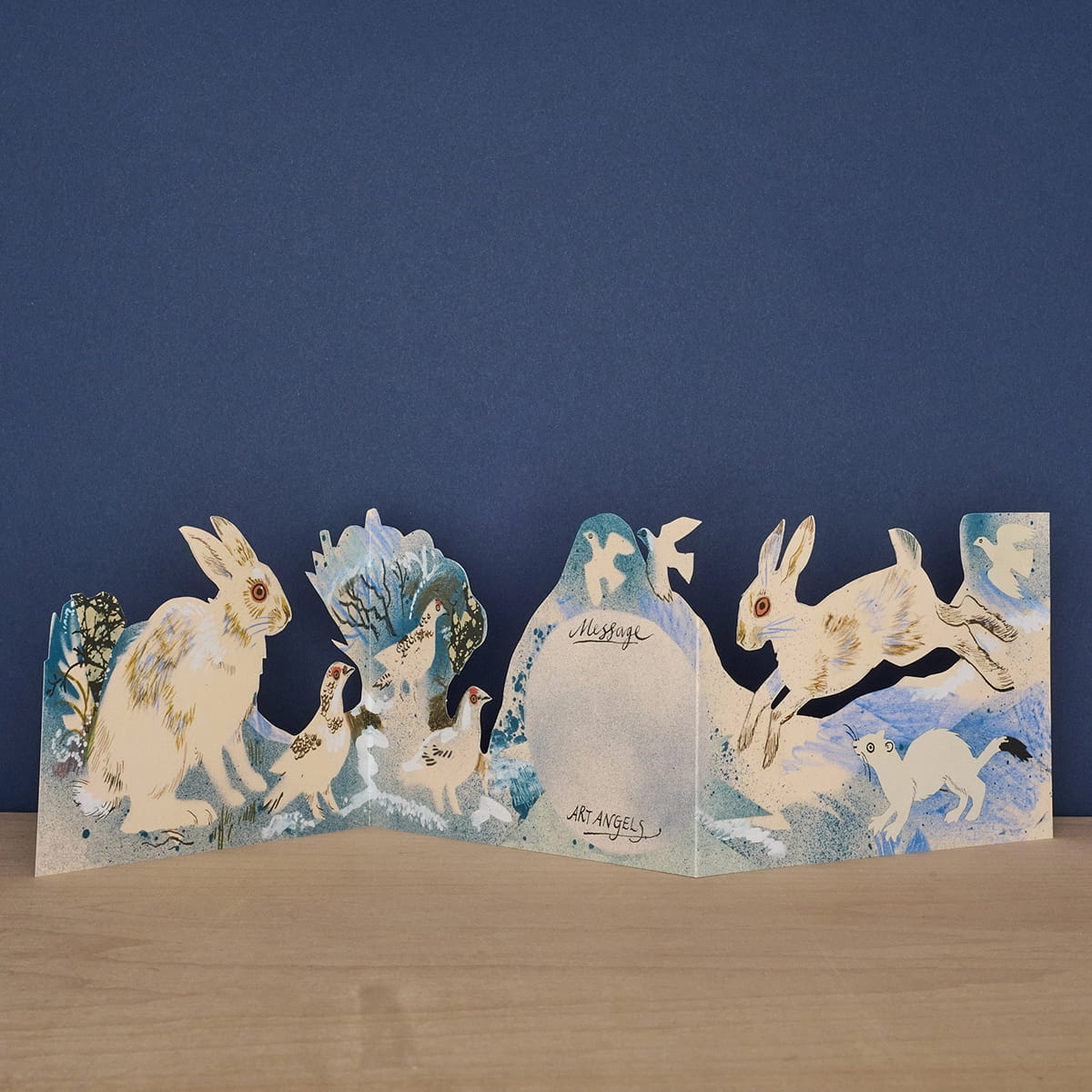 Art Angels back of die cut card with bunnies and  other wildlife in winter scene with space for handwritten note.