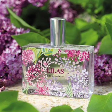 Beauty shot of Fragonard Parfumeur Lilas (Lilac) Eau de Toilette with lilacs in the background.