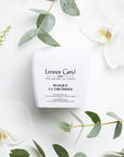 Lifestyle shot top view of Leonor Greyl Masque A L'Orchidee (200 ml) with white orchids and leaves in the background