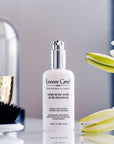Lifestyle shot of Leonor Greyl Serum de Soie Sublimateur (75 ml) with white flowers, vase and brush in the background