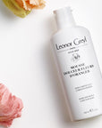 Lifestyle shot top view of Leonor Greyl Mousse Douceur Fleurs D'Oranger (For Baby) (150 ml) with flowers in the background