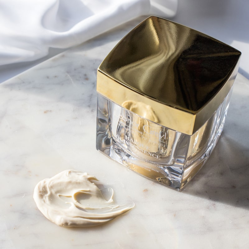 Lifestyle shot of Leonor Greyl Masque Quintessence (200 ml) with swatch on marble