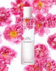 Beauty shot of Chantecaille Pure Rosewater 100 ml with rose de mai flowers in the background