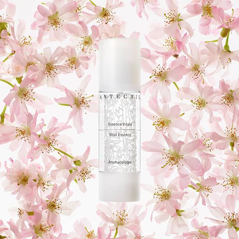 Beauty shot of Chantecaille Vital Essence 50 ml with flowers in the background