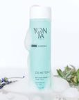 Lifestyle shot of Yon-Ka Paris Gel Nettoyant (200 ml) with soapy suds on bottle with botanical elements in the background