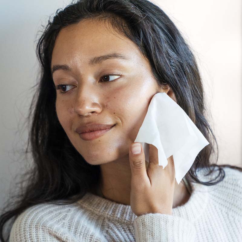 Model using a single Ursa Major Essential Face Wipe on her face