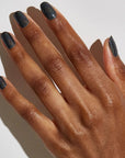 Model with dark skin tone wearing JINsoon Nail Lacquer - Mica