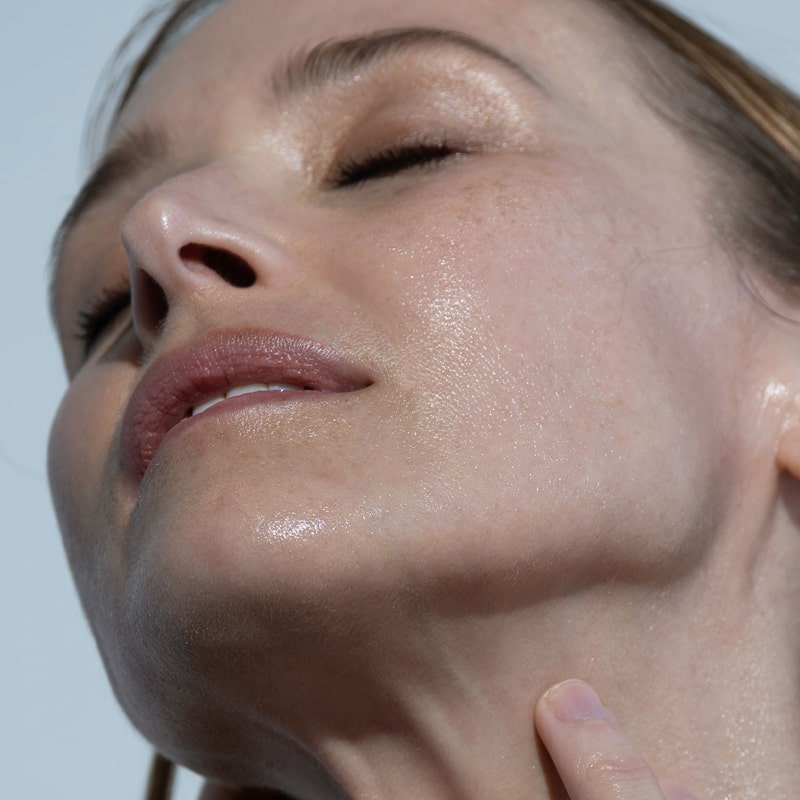 Close up of Model&#39;s face with Odacite Aloe Immortelle Hydra-Repair Treatment Mist applied
