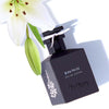 Isabey Paris Lys Noir Eau de Parfum (50 ml) with white lily flower in the background