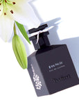 Isabey Paris Lys Noir Eau de Parfum (50 ml) with white lily flower in the background