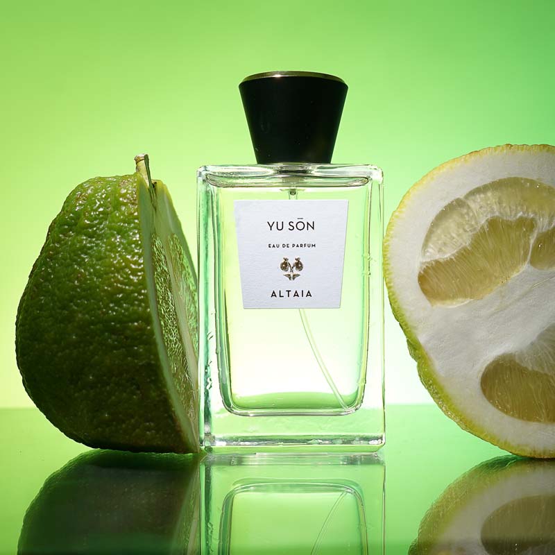 Beauty shot of ALTAIA Yu Son Eau de Parfum with fruit in the background