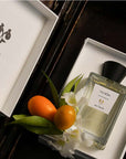 Beauty shot of ALTAIA Yu Son Eau de Parfum in box with oranges and white flowers
