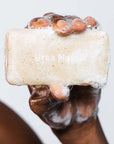 Close up shot of model holding a soapy Ursa Major Morning Mojo Bar Soap (5 oz) bar