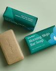Ursa Major Morning Mojo Bar Soap (5 oz) shown unwrapped and wrapped as well as side view of soap bar packaging