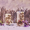 Close up lifestyle shot of Santa Maria Novella Lavender Scented Wax Tablets (2 pcs) with lavender in the foreground and background