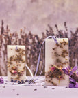 Close up lifestyle shot of Santa Maria Novella Lavender Scented Wax Tablets (2 pcs) with lavender in the foreground and background