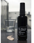 de Mamiel Exhale Daily Hydrating Nectar next to a clear glass