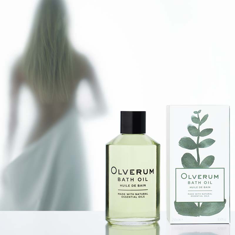 Olverum Bath Oil with box and woman silhouette in background