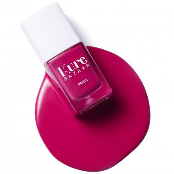 Kure Bazaar Nail Lacquer - Rose Punk / Rose Pink bottle on puddle of color