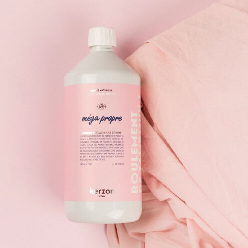 Lifestyle shot of Kerzon Fragranced Laundry Soap - Mega Propre (33.34 oz) shown top view on pink linens