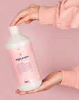 Model holding bottle of Kerzon Fragranced Laundry Soap - Mega Propre (33.34 oz)