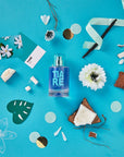 Solinotes Paris Tiare Eau De Parfum beauty shot on blue background with assorted items