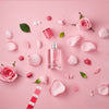 Solinotes Paris Rose Eau De Parfum beauty shot on pink background with roses and petals around