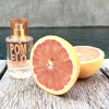 Lifestyle shot of Solinotes Paris Pomelo (Grapefruit) Eau De Parfum  (50 ml) with sliced grapefruit next to bottle