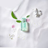 Solinotes Paris The Blanc (White Tea) Eau De Parfum with white flowers in background