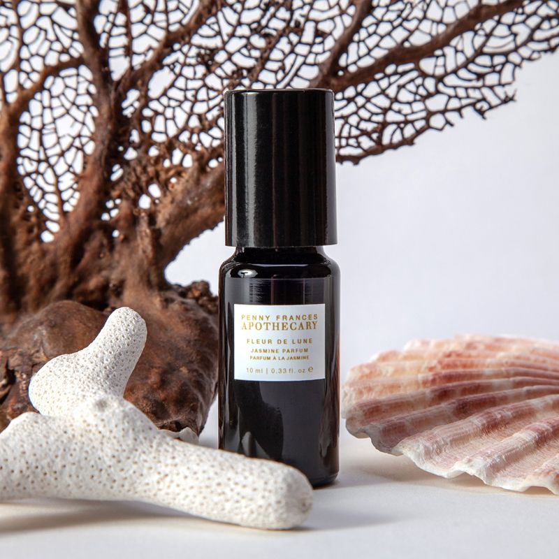 Penny Frances Apothecary Fleur de Lune Jasmine Perfume Oil Beauty Shot with seashell and coral
