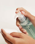 Caudalie Vinoclean Micellar Cleansing Water in model's hands about to apply to facial wipe