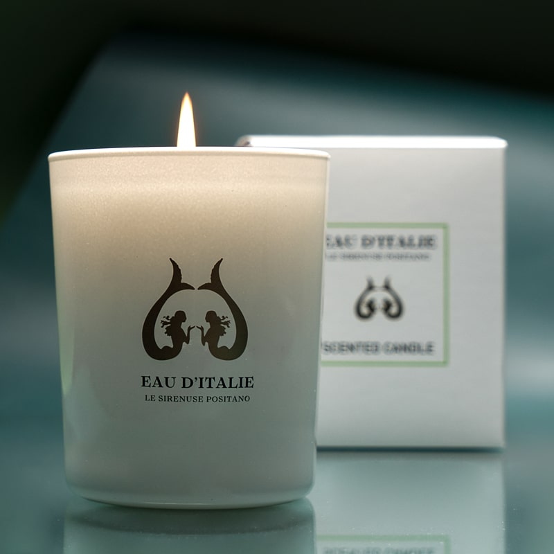 Lifestyle shot of Eau d'Italie Scented Candle (190 g) shown burning with box in the background