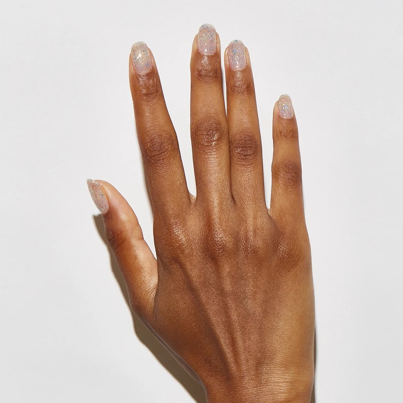 Model with dark skin tone wearing JINsoon Nail Lacquer - Absolute Glitz