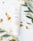 Lifestyle shot of Innersense Organic Beauty Hydrating Hair Masque 4 oz with dried flowers and green leaves in the background