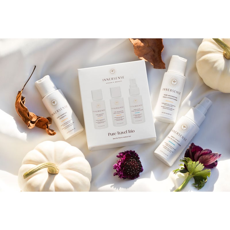 Innersense Organic Beauty Pure Travel Trio beauty shot with white pumpkins and flowers on a white cloth