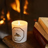 Carriere Freres Firebrand Candle pictured by books with fireplace in the background (not included)