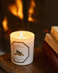 Carriere Freres Firebrand Candle pictured by books with fireplace in the background (not included)