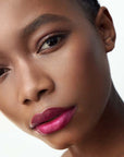 (M)ANASI 7 All Over Color Creamy Finish (5 g, Fuchsine) shown on lips of model with dark skin tone