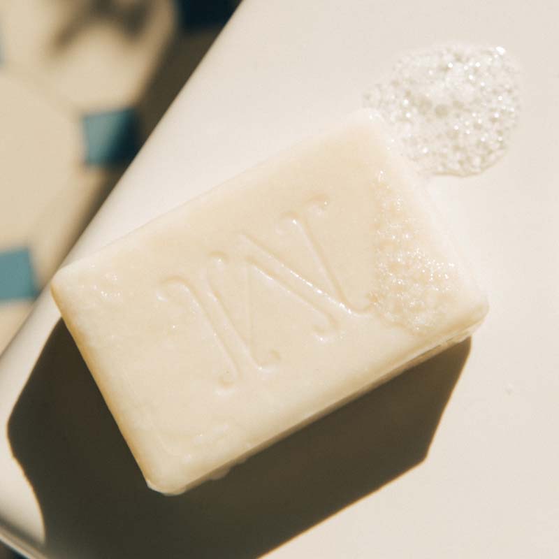Minois Paris Savon Doux (Gentle Soap) (100 g) bar shown without outer wrapper with soap suds