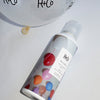 Lifestyle shot of R+Co Balloon Dry Volume Spray (5 oz) shown top view