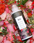 R+Co Centerpiece All-In-One Elixir Spray laying on flowers