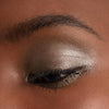Chantecaille Luminescent Eye Shade - Rhinoceros shown on eyelid of model with dark skin