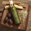 Beauty shot of Rahua by Amazon Beauty Founder's Blend Scalp & Hair Treatment (38 ml) lifestyle shot top view with ingredients and wood in the background