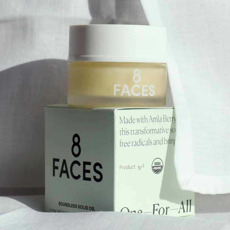 Lifestyle shot of 8 Faces Boundless Solid Oil (1.7 oz) with box