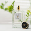 Lifestyle shot of ALTAIA Wonder of You Eau de Parfum (100 ml) with top of bottle off and posed facing front