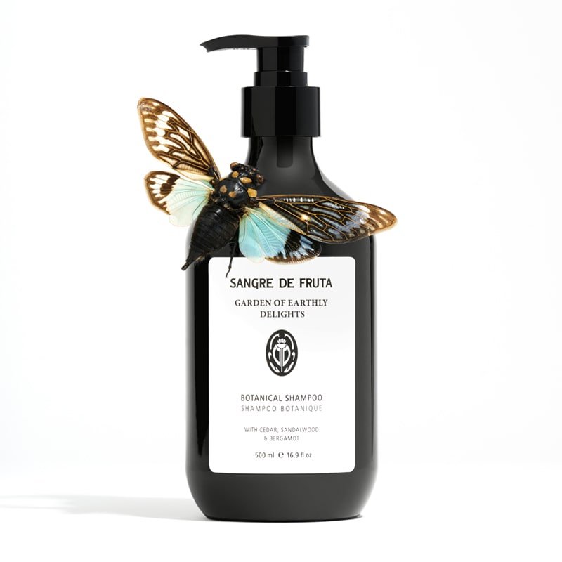Lifestyle shot of Sangre de Fruta Botanical Shampoo Garden of Earthly Delights (500 ml) with moth on bottle
