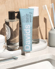 Davids Premium Natural Toothpaste - Spearmint (5.25 oz) on sink top with toothbrushes