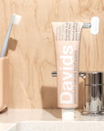 Davids Premium Natural Toothpaste - Herbal Citrus Peppermint (5.25 oz) on bathroom sink top with toothbrush